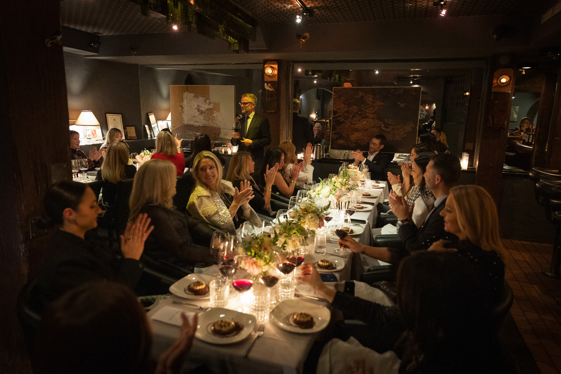 Private corporate dinner — candlelight, applause, intimate room
