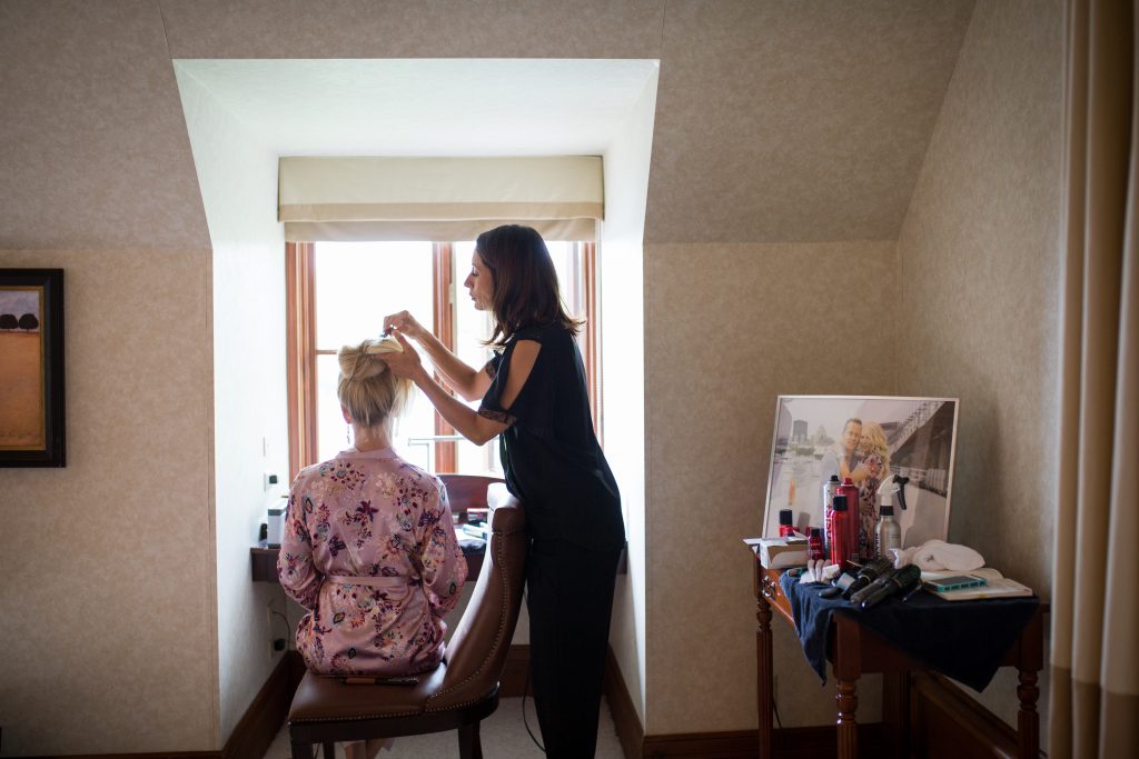 Wedding photographer Montreal, bride getting her hair done on her wedding day