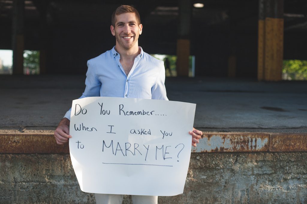 Montreal wedding photography groom holding up proposal