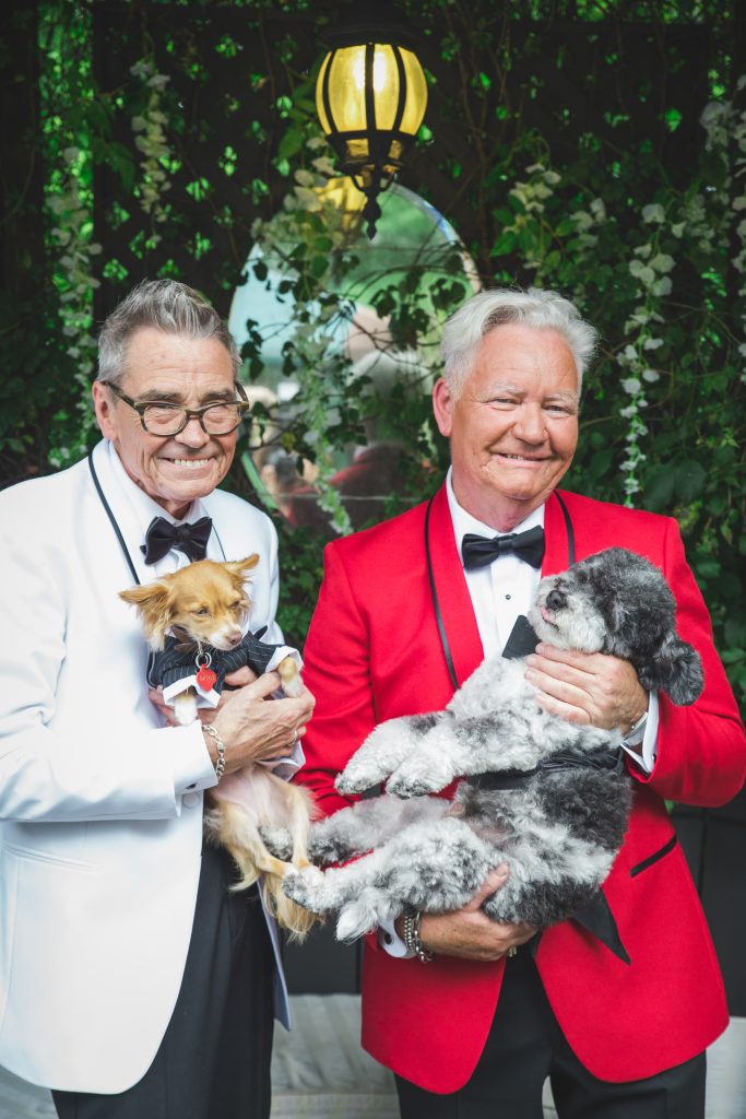 groom and groom with their dogs in tuxedos