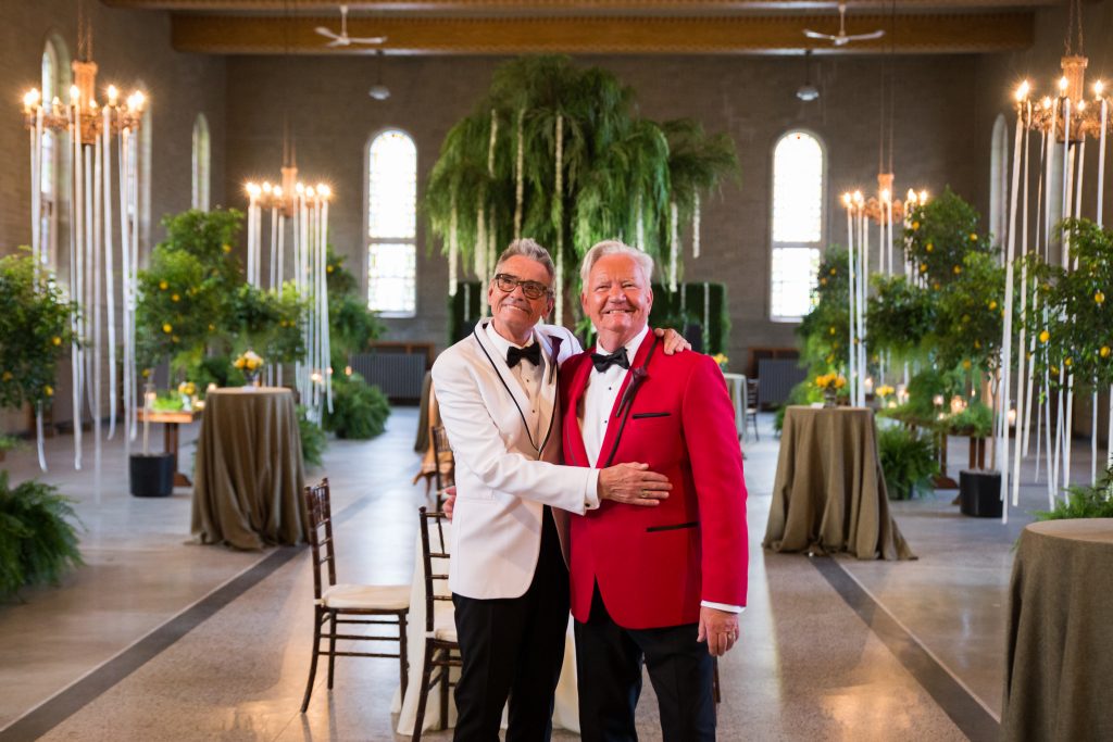 groom and groom standing at their wedding reception tuscan decor