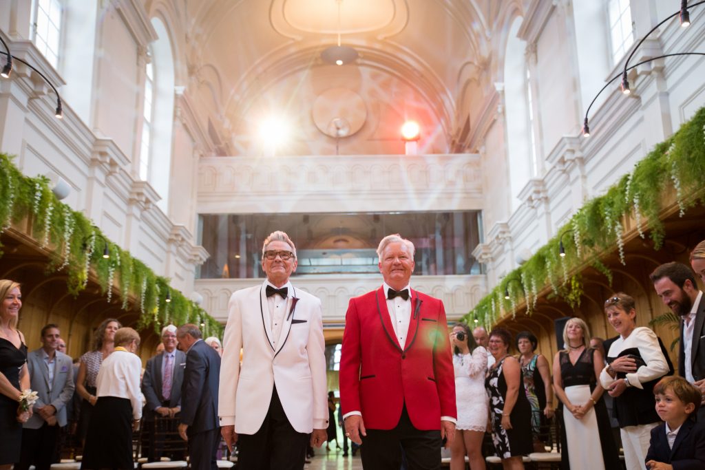 Groom and groom walking down the aisle at their wedding ceremony