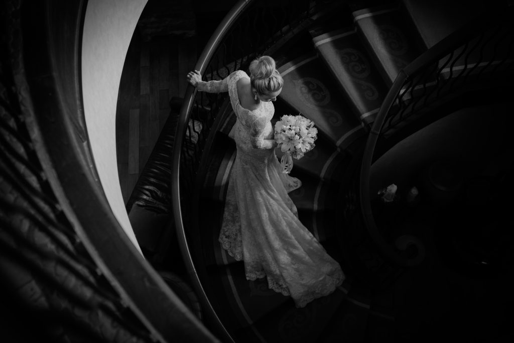 Montreal wedding photographer at hotel Quintessence black and white photo of a bride on the staircase