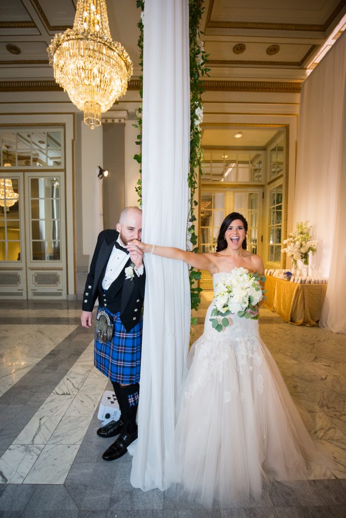 Montreal wedding photographer. Bride and groom divided between a curtain before they see eachother