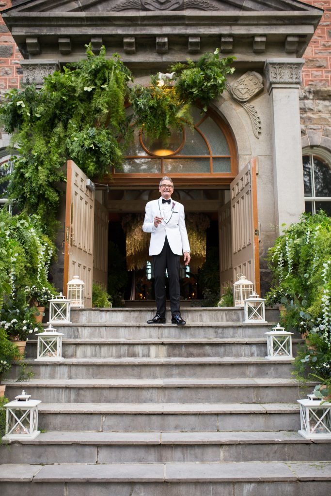 Groom standing at the top of staircase