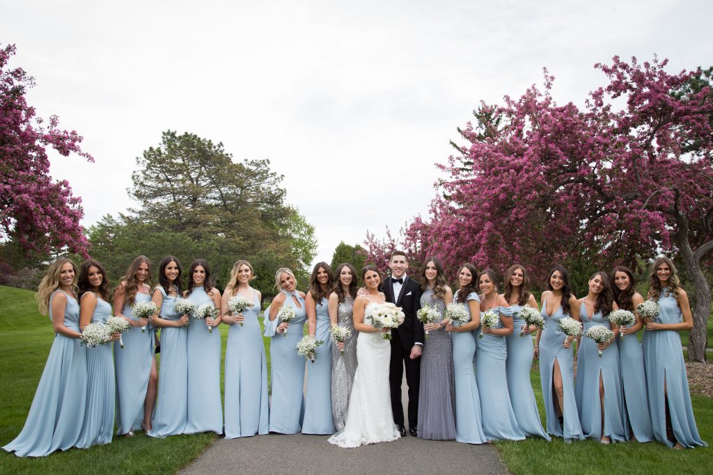 groom with all bridesmaids in blue dresses and bride with cherry blossoms surrounding them on their wedding day, Montreal