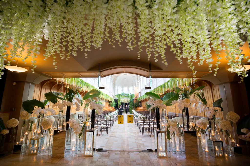 Flowers cascading from the ceiling, flowers surrounding the entrance of the ceremony at abbaye, oka