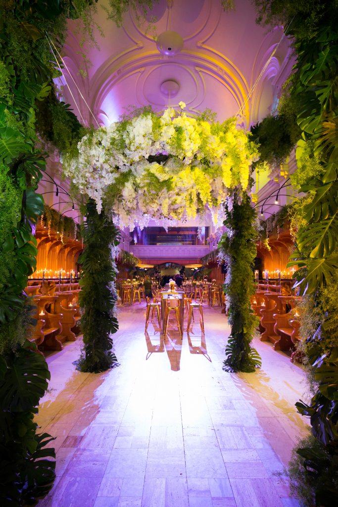 greenery huppah with orchids cascading down during reception wedding