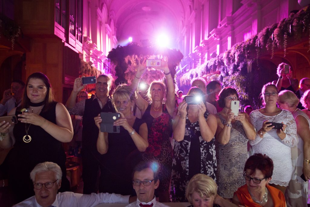 Wedding guests taking pictures with their cellphones at a wedding reception, abbaye, oka