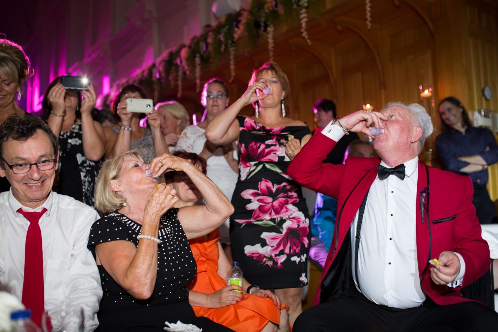 Guests with the groom doing shots at their wedding reception, Abbaye, d'OKA