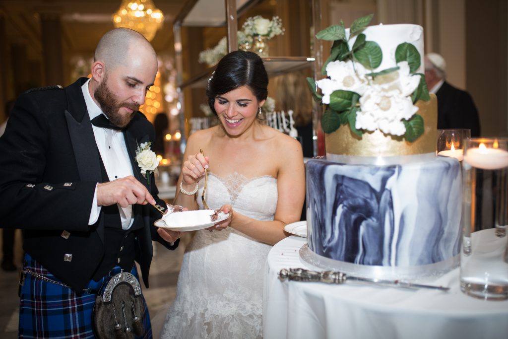 Photography by Christina Esteban Photography bride and groom on their wedding day eating wedding cake