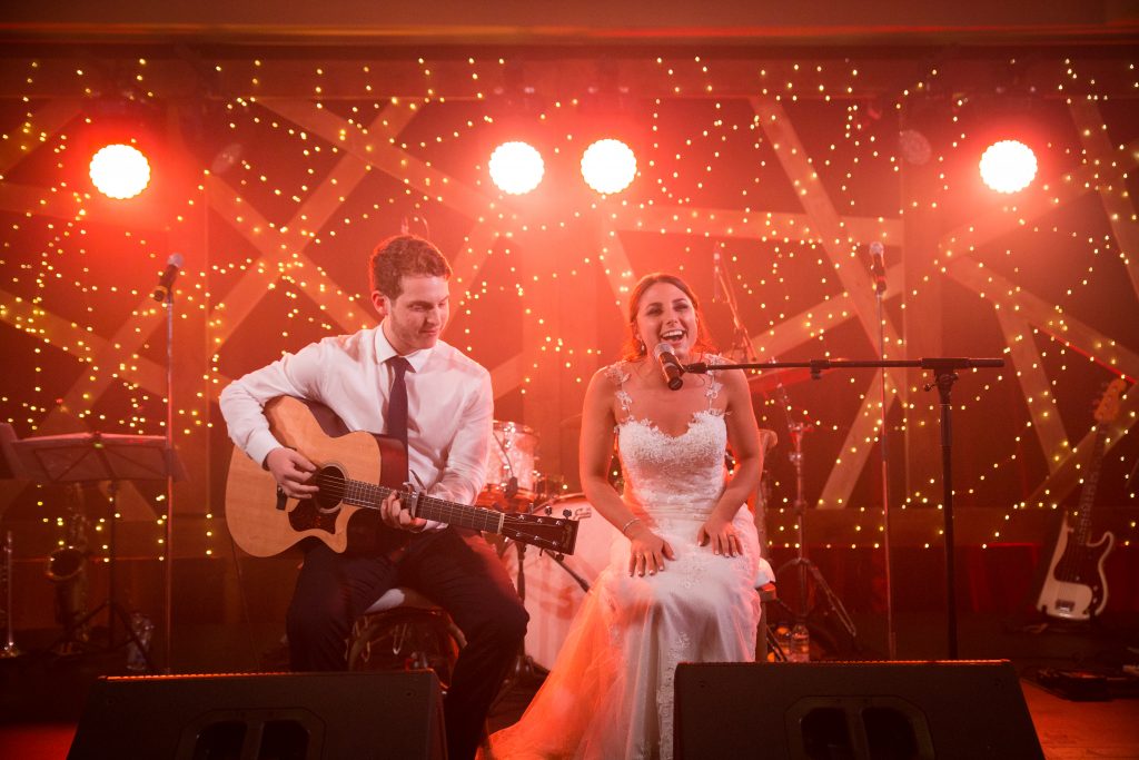 Bride singing to her groom on stage for her wedding day in Montreal