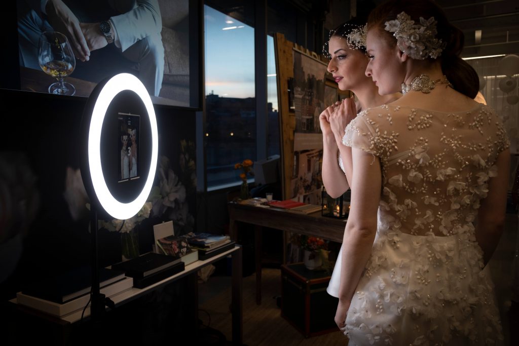 Models in wedding gowns trying our selfie booth